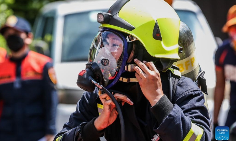 A female firefighter participates in the Women Firefighters Skills Olympics at the Philippine Bureau of Fire Protection-National Capital Region (BFP-NCR) headquarters in Quezon City, the Philippines on March 14, 2022.(Photo: Xinhua)