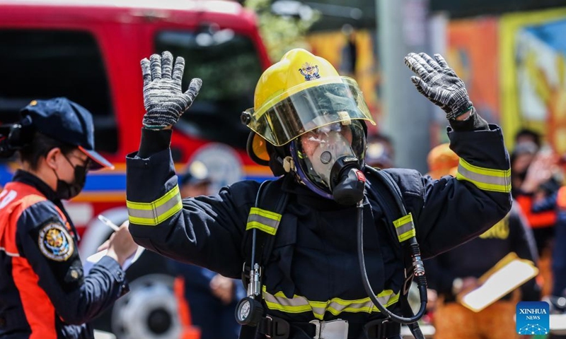 A female firefighter participates in the Women Firefighters Skills Olympics at the Philippine Bureau of Fire Protection-National Capital Region (BFP-NCR) headquarters in Quezon City, the Philippines on March 14, 2022.(Photo: Xinhua)